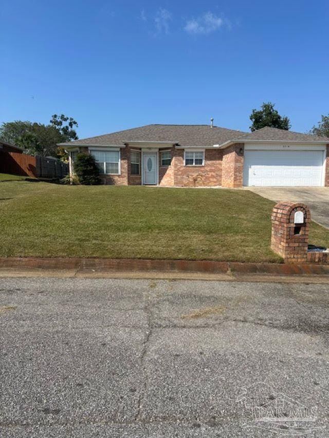 ranch-style house with a garage, brick siding, driveway, and a front lawn