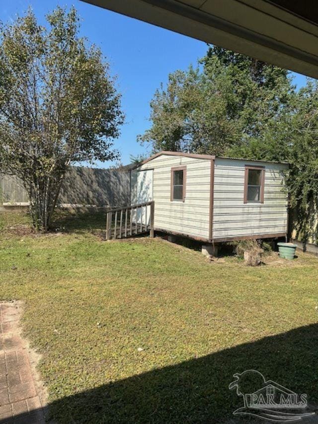 view of yard with an outbuilding and fence