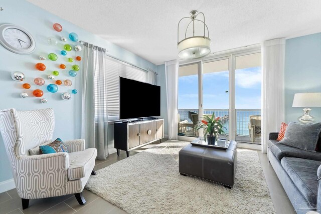 tiled living room with a chandelier