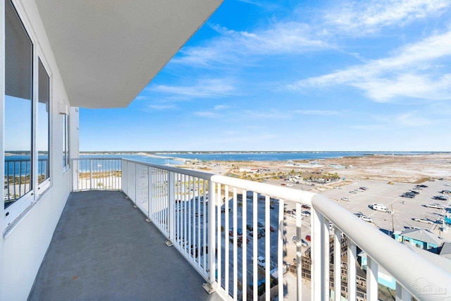 balcony featuring a water view and a view of the beach