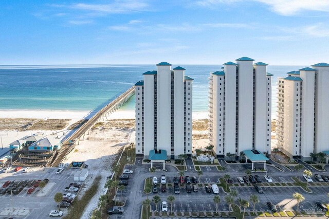 birds eye view of property with a water view and a view of the beach