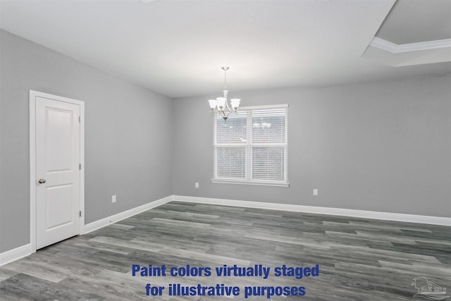 spare room with wood-type flooring and a notable chandelier