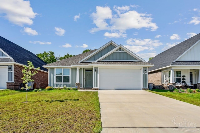 craftsman house featuring a garage and a front yard