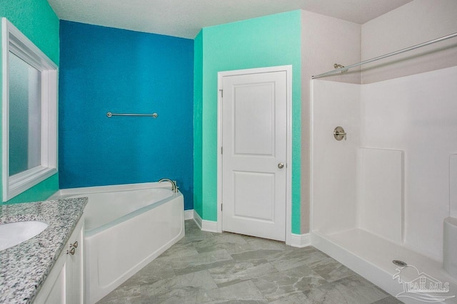 bathroom featuring vanity and shower with separate bathtub