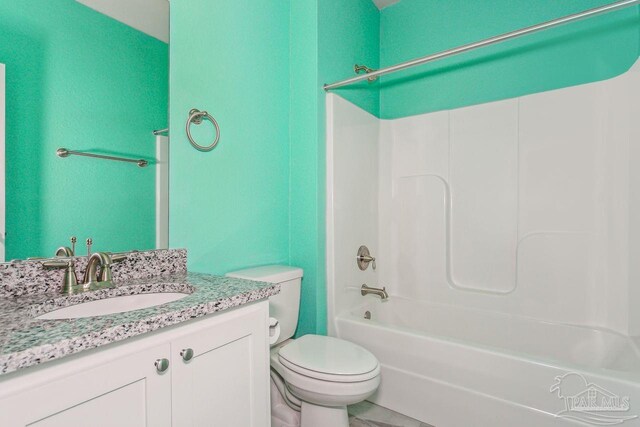 full bathroom featuring vanity, bathtub / shower combination, and toilet