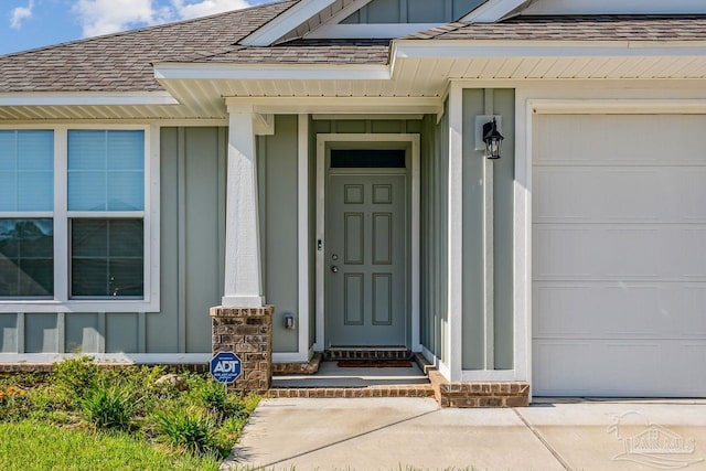 view of exterior entry with a garage