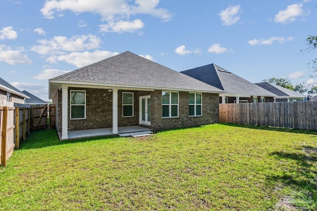 back of property featuring a yard and a patio area