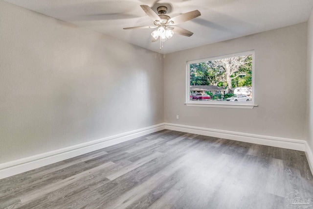 spare room featuring ceiling fan and hardwood / wood-style flooring