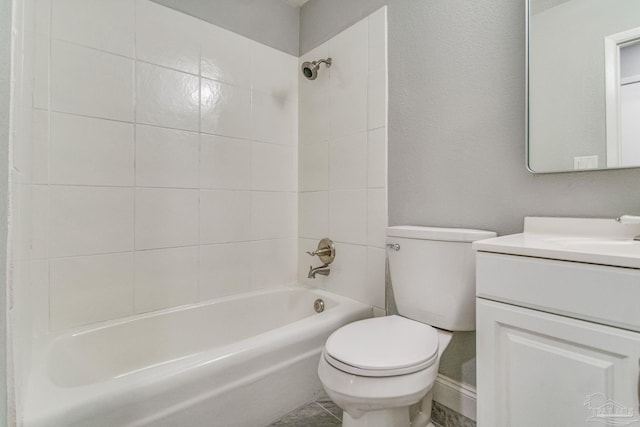 full bathroom with toilet, vanity, and tiled shower / bath