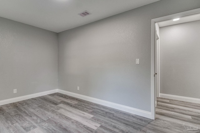 unfurnished room with light hardwood / wood-style flooring