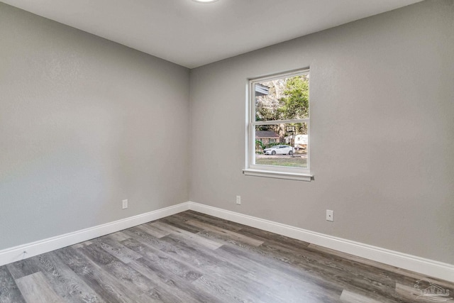 unfurnished room with hardwood / wood-style flooring