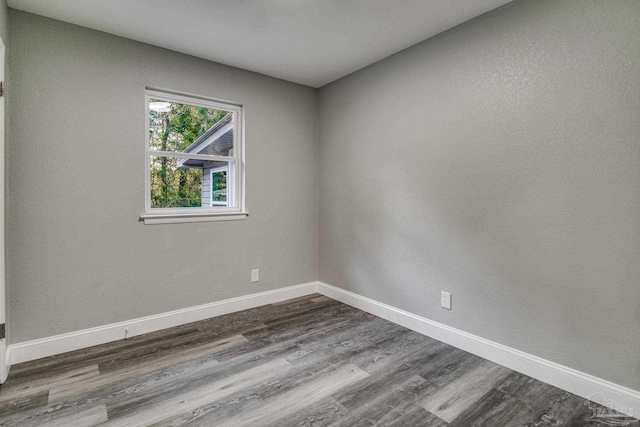 unfurnished room with hardwood / wood-style flooring