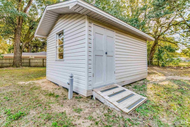 view of outbuilding with a lawn