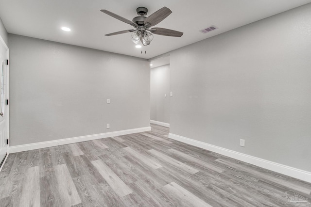 empty room featuring ceiling fan and light hardwood / wood-style flooring