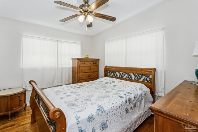 bedroom featuring ceiling fan and dark wood finished floors