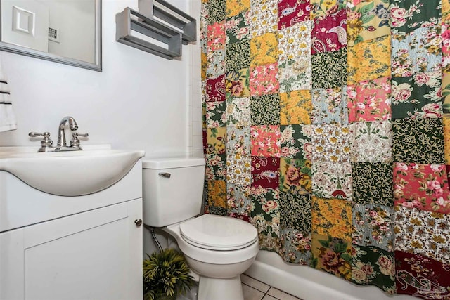 bathroom with toilet, vanity, tile patterned flooring, and curtained shower