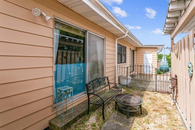 view of patio / terrace with an outdoor fire pit and fence