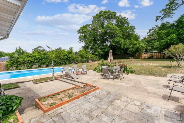 view of swimming pool featuring a fenced in pool, a yard, a patio, and a fenced backyard