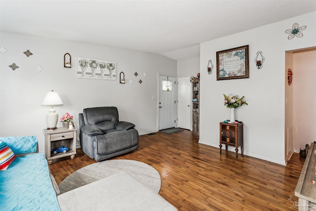 living room with baseboards and wood finished floors
