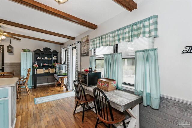 dining room featuring beam ceiling and hardwood / wood-style floors