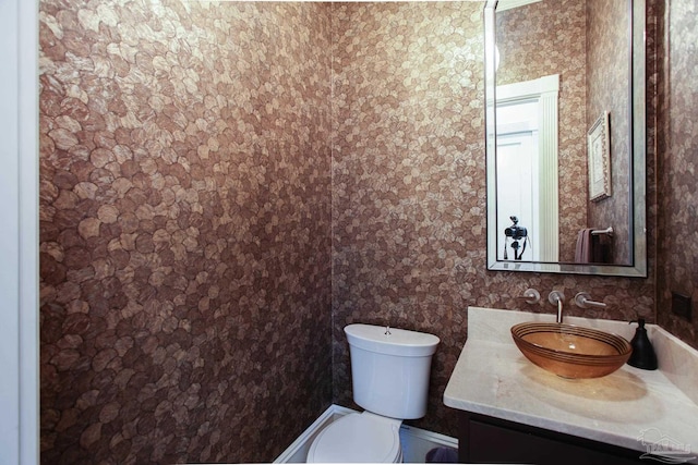 bathroom with toilet and vanity