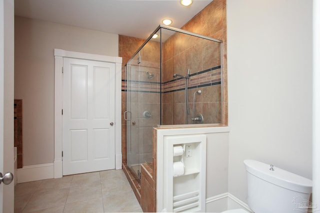 bathroom with toilet, tile patterned flooring, and walk in shower