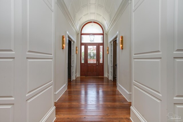 entrance foyer with baseboards, dark wood finished floors, and lofted ceiling