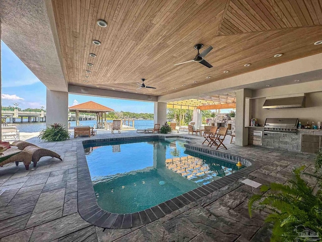 outdoor pool featuring a patio area, a gazebo, exterior kitchen, ceiling fan, and area for grilling
