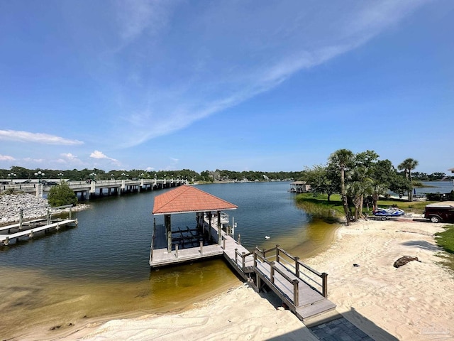 dock area featuring boat lift and a water view
