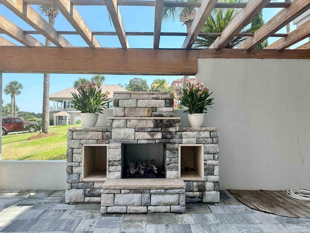 view of patio / terrace featuring an outdoor stone fireplace and a pergola