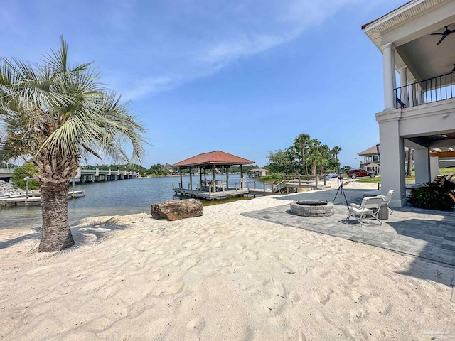 view of yard with a fire pit, a water view, and a gazebo