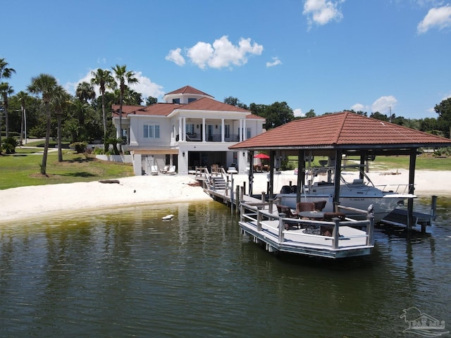 view of dock featuring a water view, boat lift, and a balcony