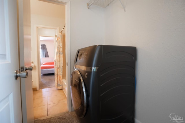 laundry area with washer / dryer and tile patterned floors