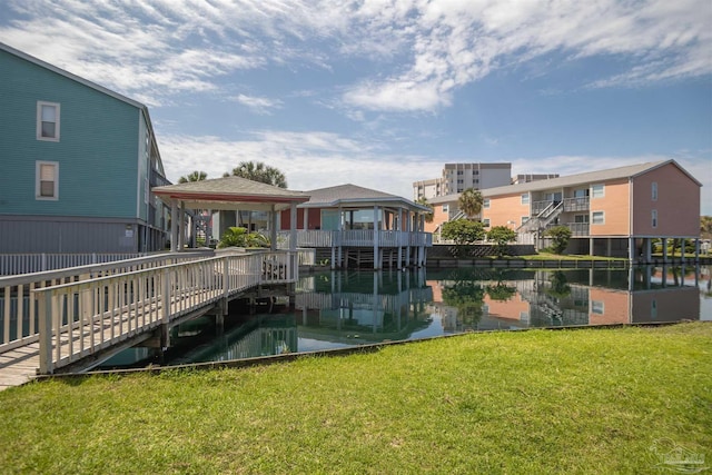 view of property's community featuring a gazebo, a lawn, and a water view