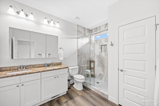 5379 Longhorn Trl, Gulf Breeze, FL 32563 - full bathroom featuring a marble finish shower, double vanity, and wood finished floors