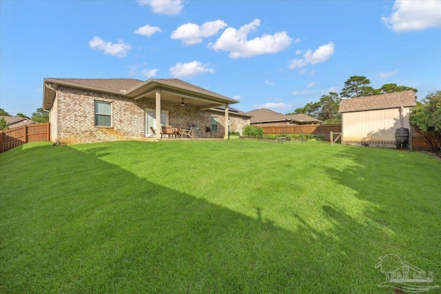 5379 Longhorn Trl, Gulf Breeze, FL 32563 - rear view of house featuring a fenced backyard, a patio area, a shed, brick siding, and ceiling fan