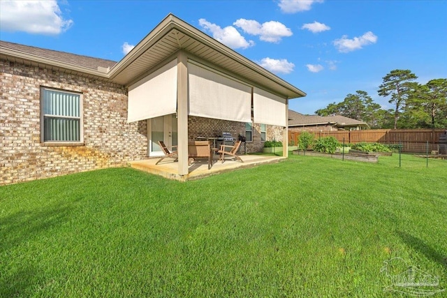 5379 Longhorn Trl, Gulf Breeze, FL 32563 - rear view of property featuring a patio area, brick siding, and a garden