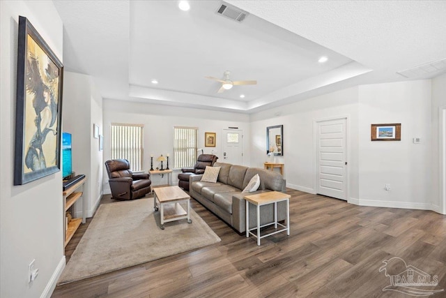 5379 Longhorn Trl, Gulf Breeze, FL 32563 - living room with wood finished floors, a tray ceiling, a ceiling fan, and recessed lighting