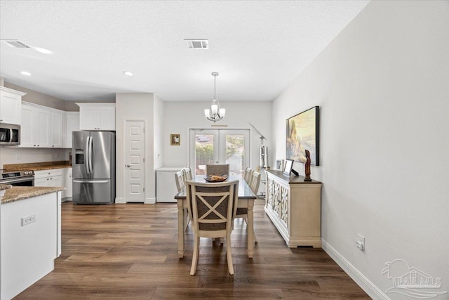 5379 Longhorn Trl, Gulf Breeze, FL 32563 - dining space with a chandelier, dark wood-type flooring, and recessed lighting