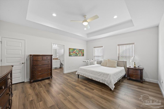 5379 Longhorn Trl, Gulf Breeze, FL 32563 - bedroom featuring a raised ceiling, dark wood finished floors, recessed lighting, ceiling fan, and connected bathroom