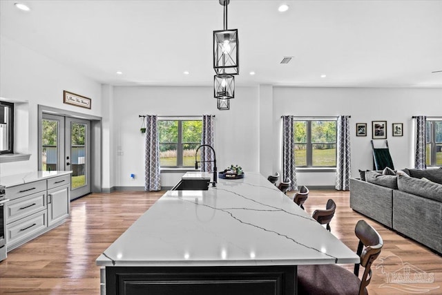 kitchen with recessed lighting, plenty of natural light, and open floor plan