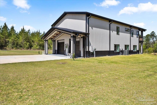 view of side of property featuring a yard and central AC unit