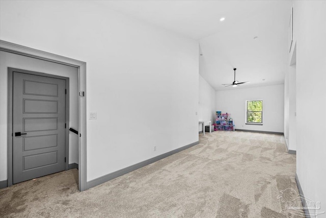 unfurnished living room with ceiling fan, recessed lighting, carpet flooring, lofted ceiling, and baseboards