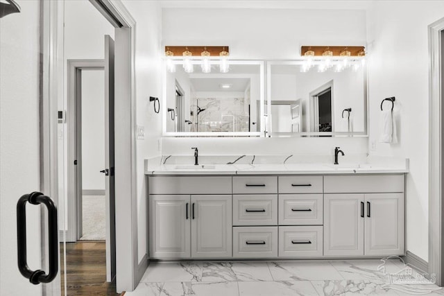 full bathroom with a sink, double vanity, and marble finish floor