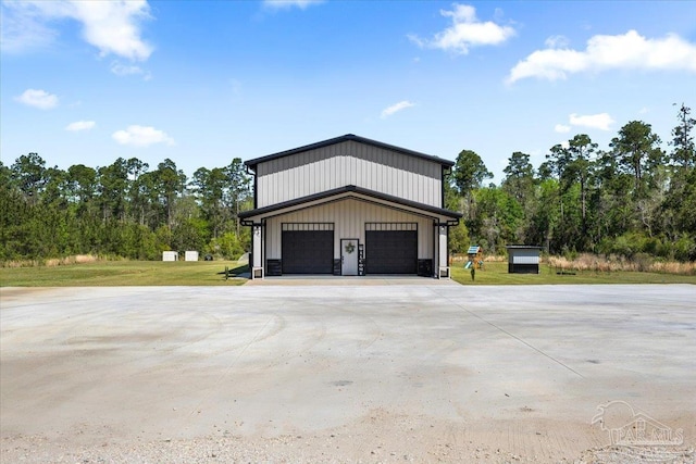 view of property exterior with an outdoor structure, a lawn, and a detached garage