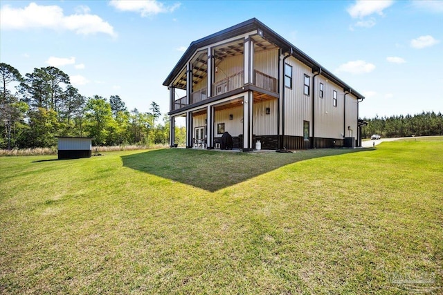 rear view of property featuring a yard