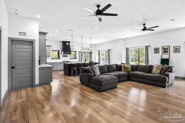 living area featuring recessed lighting, visible vents, and light wood-style flooring