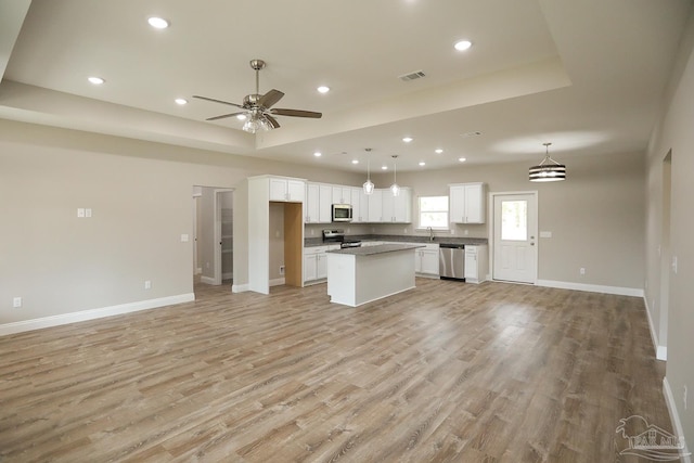 kitchen featuring white cabinetry, visible vents, open floor plan, and appliances with stainless steel finishes