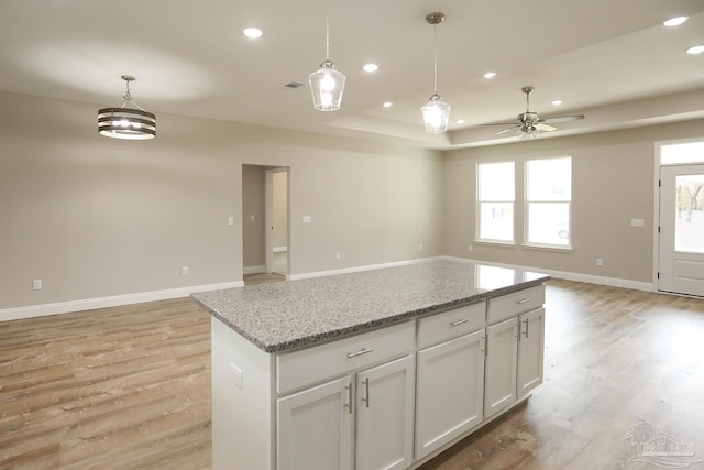 kitchen with recessed lighting, open floor plan, light wood finished floors, and pendant lighting