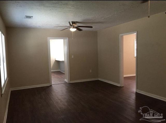 empty room with a textured ceiling, ceiling fan, and hardwood / wood-style floors